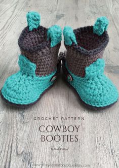 two crocheted baby booties sitting on top of a wooden floor