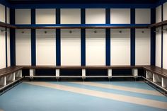 an empty room with blue and white stripes on the floor