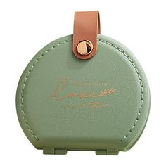 a small green case with a key chain attached to the front and side of it