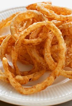 some onion rings are on a white plate