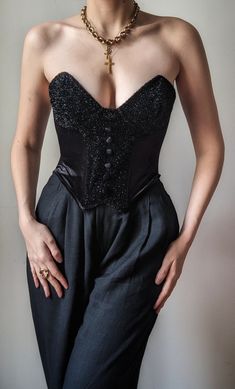 Incredible vintage bustier from the 1990s, a creation by the luxurious Italian corsetry house Ritmo di Perla. It is an exceptional piece, of impeccable quality, made in Italy. It is made from rich black velvet with a luxurious sheen, with inserts covered with silver threads that shine brightly. Velvet covered buttons decorate the front on the bust. The back is also shiny, and opens with an extremely discreet zipper. It has flexible but shaping underwires, allowing you to sculpt the silhouette bu Luxury Lace Trim Bustier Bodice, Luxury Bustier Bodice For Women, Luxury Shapewear Bustier, Luxury Bra-friendly Bustier, Luxury Romantic Bustier Bodice, Luxury Women's Underwire Corset, Luxury Vintage Bustier Bodice, Luxury Bustier With Contrast Lace, Luxury Nylon Bustier Corset