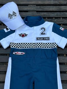 Give your little one's style a speed boost with our Personalized Blue Racer Jumpsuit for Kids! 🚗 Choose between Short, ShortSleevePant, or Long Suit options to match their racing spirit. 🏁 👶🏻 Crafted from 100% COTTON, this racing overall is tailor-made for toddlers. The FULLSET option adds a special touch with a name patch, back name, and number customization, making their outfit uniquely theirs. 🌟 ⭐ Complete the racing look by pairing it with a stylish Checkered or Blue hat! 🧢 Looking for Racing Jumpsuit, Racer Jumpsuit, Racer Costume, Car Costume, Race Outfit, Long Suit, Jumpsuit For Kids, Name Patches, Blue Hat