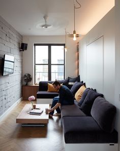 a man sitting on a couch in a living room