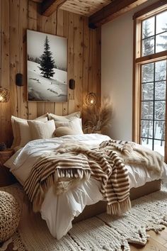 a bedroom with wood paneled walls and white bedding in front of a large window