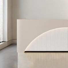 a white sculpture sitting in the middle of a room next to a window with blinds on it