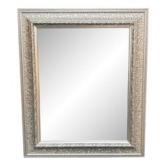 an ornate silver framed mirror on a white background with the reflection of it's own image