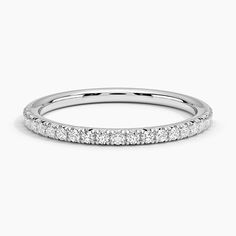 a white gold wedding band with rows of diamonds