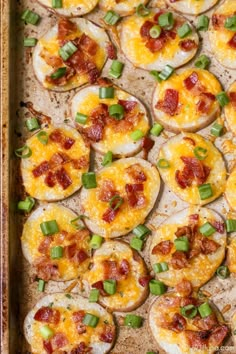 baked potato skins with bacon and green onions in a baking pan, ready to be eaten