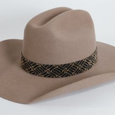 A gold colored beaded hat band is a stunning accessory that can add a touch of glamour and sophistication to any hat. Made with small, intricate beads in shades of gold, this hat band sparkles and catches the light, creating a dazzling effect that draws the eye. **Please note this is the hatband only** Gold Western Fedora Hat, Gold Fedora Western Hat, Western Gold Hat Bands For Party, Western Style Gold Hat Bands For Parties, Gold Curved Brim Hat Band For Party, Gold Hat Band For Party With Curved Brim, Gold Flat Brim Hat For Rodeo, Elegant Adjustable Beige Hat Bands, Gold Brimmed Hat For Rodeo