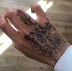 a person's hand with a tattoo on it