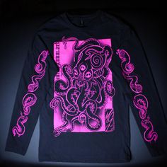 Original and unique designs printed on lightweight black long sleeve sweater with UV reactive neon pink water based ink. An octopus on the front and 4 tentacles along each arm, all featuring spirals and a third eye! Screen printed and retouched by hand. Washed and dried beforehand to ensure durability of the print. Permaset Aqua Supercover brand ink, Gildan brand sweater. I am wearing size medium in the photos. - clothing specs - 4.5 oz./yd² (US) 7.5 oz./L yd (CA), 100% ring-spun cotton, 30 singles Narrow width, rib collar Taped neck and shoulders for comfort and durability Side seams Tear away label Made with OEKO-TEX certified low-impact dyes Fitted Long Sleeve T-shirt With Band Merch, Long Sleeve Punk Tops With Graffiti Print, Punk Long Sleeve Tops With Graffiti Print, Pink Long Sleeve T-shirt With Graphic Print, Long Sleeve Punk Graphic T-shirt, Unisex Long Sleeve Band Merch T-shirt, Long Sleeve Band Merch Top With Screen Print, Unisex Long Sleeve T-shirt For Streetwear, Long Sleeve Graffiti Print T-shirt For Streetwear