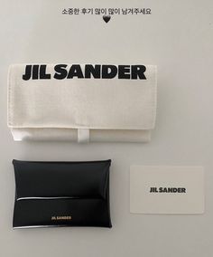 an assortment of items are displayed on a white surface with black and white lettering that reads jil sander