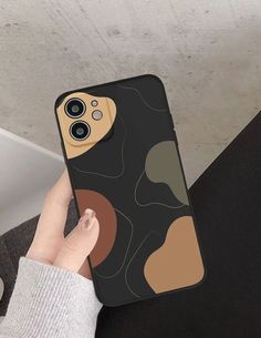 a person holding up an iphone case with a design on it