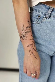 a woman with a flower tattoo on her arm