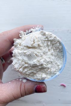 a hand holding a powdered white substance