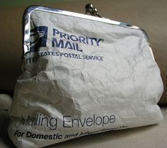 a bag that is sitting on top of a couch with the words mailing envelope printed on it