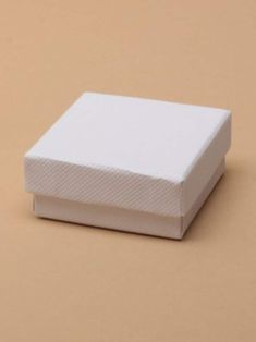 a white box sitting on top of a brown surface