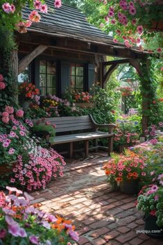 a garden with flowers and a bench in the foreground, surrounded by greenery