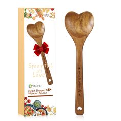 a wooden spoon with a red bow on it next to a cardboard box and packaging