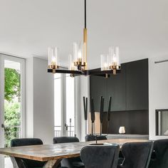 a dining room table with chairs and a chandelier