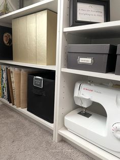 a sewing machine sitting on top of a white shelf