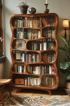 a bookshelf filled with lots of books in a living room next to a window