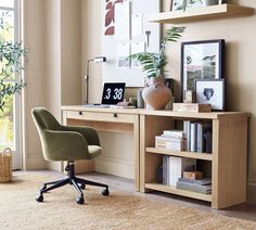 a desk with a chair, bookshelf and pictures on the wall