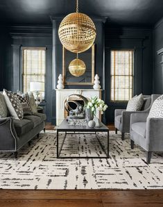 a living room filled with furniture and a fire place in the middle of the room