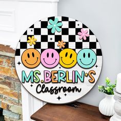 a sign that says ms berlin's classroom with smiley faces and flowers on it