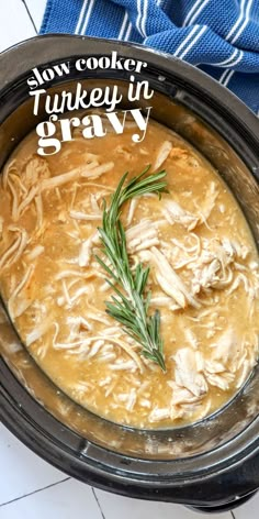 slow cooker turkey in gravy with rosemary garnish on the side