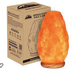 an orange himalayan salt lamp sitting in front of a box