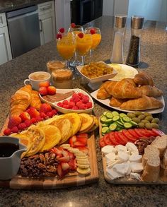 an assortment of fruits and pastries on a kitchen counter