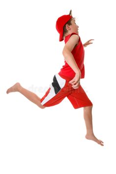 a young boy in red and white running