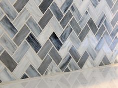 a white and grey tile backsplash in a bathroom