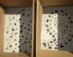 two open boxes with rocks in them on the floor