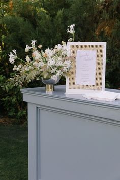 a table with flowers and a card on it