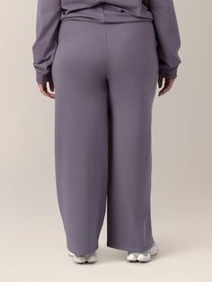 Get ready to step into cozy. The Mila Pant is the perfect choice to keep you ultra-comfy and cute during the postpartum period. The cotton-blend fabric features a jersey exterior with a super-soft, fuzzy fleece interior. The high-waisted design, wide-leg cut, and sleek piping detail add effortless style to the postpartum pants of your dreams.   Perfect for postpartum and nursing moms Fitted at waist with stretchy elastic waistband and adjustable drawcord Loose through the thigh and ankle for a r Cozy Bottoms For Relaxation, Solid Color Comfort Stretch Pants For Relaxation, Comfort Stretch Pants For Relaxation, Solid Yoga Pants With Elastic Waistband For Relaxation, Elastic Waistband Solid Color Relaxation Pants, Cozy Solid Color Bottoms For Relaxation, Comfy Bottoms With Comfort Waistband, Full Length Sweatpants With Comfort Waistband For Relaxation, Comfy Bottoms With Comfort Waistband For Relaxation