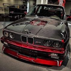 a red and black car parked in a garage