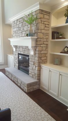 a living room filled with furniture and a fire place in the middle of a room