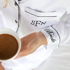 a person holding a cup of coffee in their hand with the word san francisco printed on it