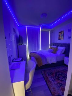 a bed room with a neatly made bed and purple lighting