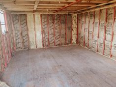 an unfinished room with wooden floors and walls covered in construction materials, including insulation tape