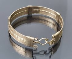 An very unusual 9ct rolled gold wire bangle. It consists of gold wire strands that are wound around the bangle at intervals and also finishing off each end. Hook and eye clasp are also made from these rolled gold sturdy wires. Dates from around 1910-1930. Good condition, wear to the rolled gold is present but commensurate with age. Width is 10mm Diametr is 5.4cm Bangle Design, Wire Cuff, Wire Bangles, Cool Diy Projects, Fun Diy, Gold Wire, Antique Art Deco, Cuff Bangles, Antique Art