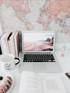 an open laptop computer sitting on top of a white desk