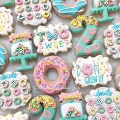 many decorated cookies are displayed on a table