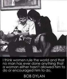 two people are sitting on a couch and one is playing an electric guitar with the caption, i think women rule the world and that no man has ever done anything that