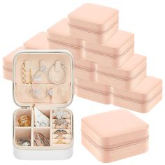 a set of six pink jewelry boxes filled with different types of rings and bracelets