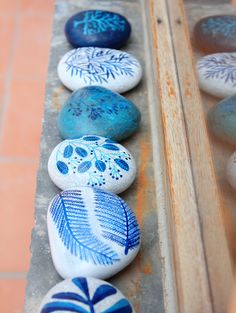 painted rocks are lined up on the ground