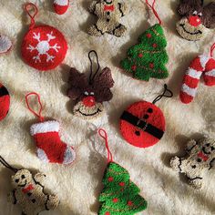 crocheted christmas ornaments are arranged on a blanket