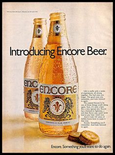 an advertisement for encore beer with two bottles and one cookie on the table